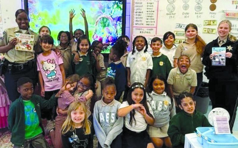 Dep. Paradise Donaldson and Dep. Isabel Dodt, both of the Corrections Division at the Parish Prison, joined Arabi Elementary students for storytime during Literacy Week.