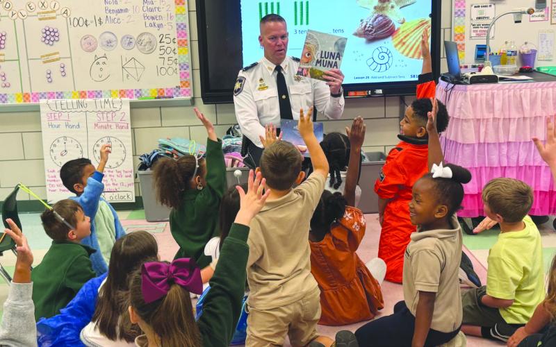 Col. Daniel Bostic, commander of SBSO’s Special Investigations Division, engaged Arabi Elementary students while reading a book during Literacy Week.