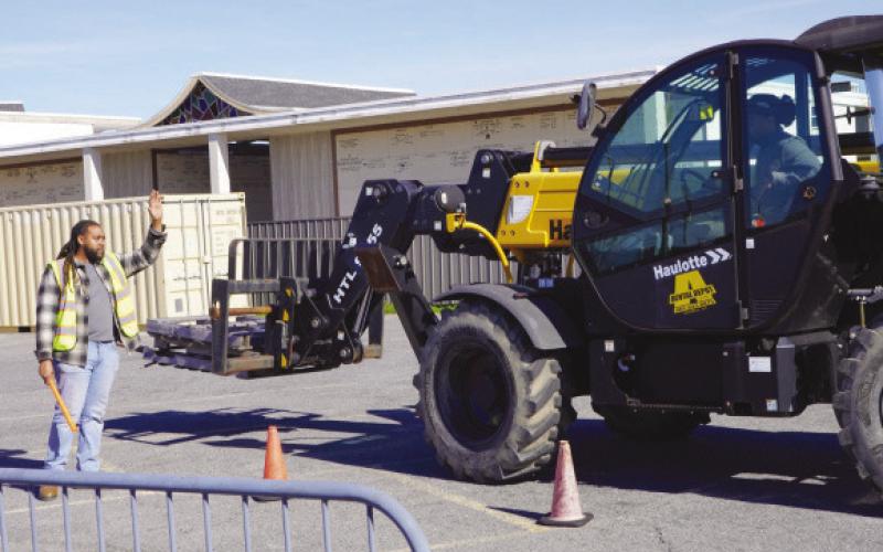 Heavy Equipment students practice operating and directing a telescoping forklift on the Nunez campus.