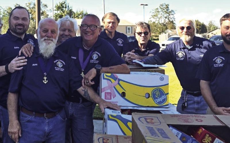 The Knights of Columbus Our Lady of Lourdes Council 8442 continued their tradition of community service this Thanksgiving by donating 50 turkeys and all the fixings for a meal to parishioners of Our Lady of Lourdes Catholic Church. From left, are: Chester Vucinovich, Dep. Robert Maloz Jr., Keith Black, Knights of Columbus Council 8442 Grand Knight; Norman Landry, Bryan Keller, Hector Perez, Knights financial secretary; Keith Dier, Knights program coordinator; and Randy Unbehagen.