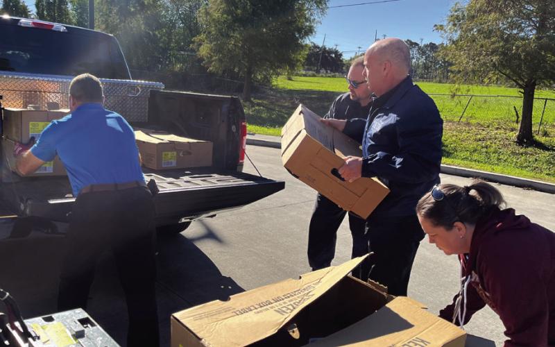 Col. Kevin Sensebe, Knights of Columbus 8442 Community Director and St. Bernard Sheriff's Office Parish Prison warden, and Dep. Robert Maloz Jr., Knight of Columbus Council 8442 member and a member of the SBSO Corrections Division, pick up turkeys that were distributed to families in need by Our Lady of Lourdes Catholic Church.