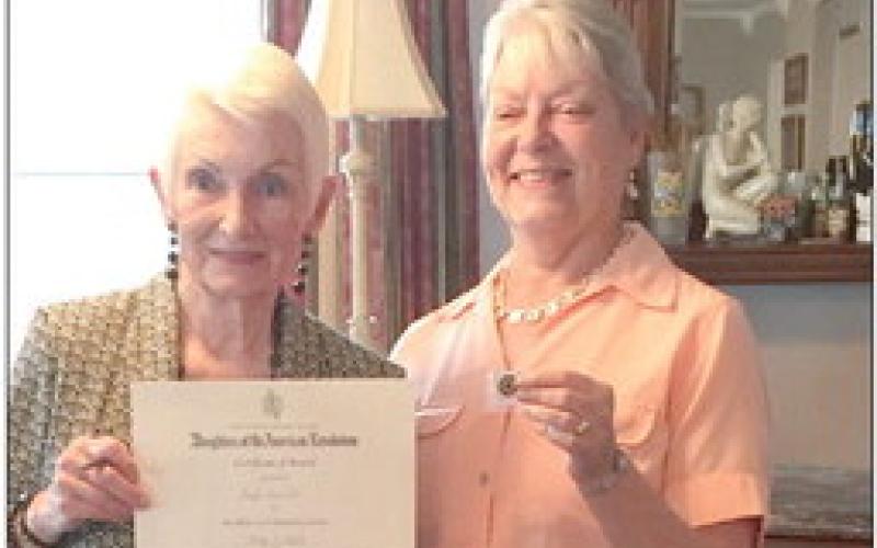 At the annual Francois de Lery Chapter Daughters of the American Revolution tea, the Community Service Award was presented to Gayle Farrell (pictured on the left) for her many hours of volunteering, especially at the St. Bernard Parish Library. Presenting the award is Chapter Treasurer Christyn Elliott.