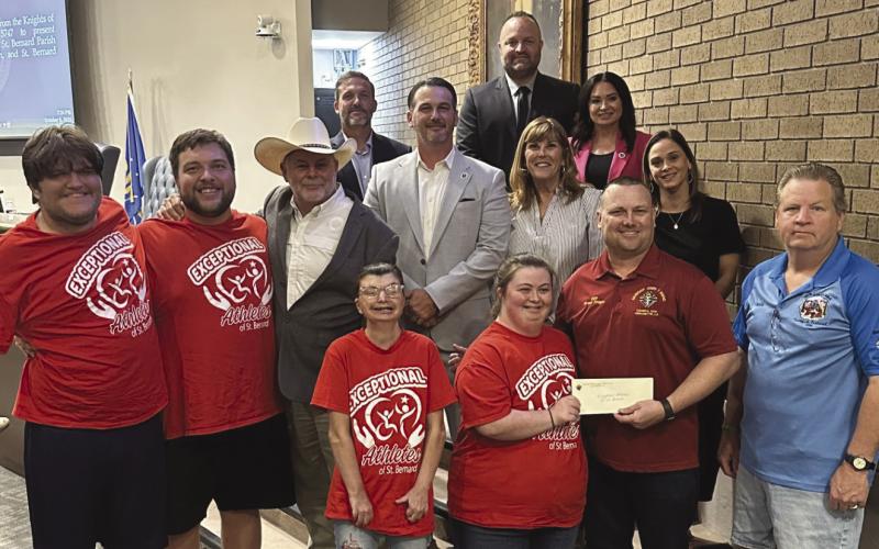 Parish President Pomes and council pose with Grand Knight for the St. Bernard Knights of Columbus Chapter Cli Bigner as he gives $1,000 donation checks to the Council on Aging, St. Bernard Autism Krewe, the Exceptional Athletes of St. Bernard, and the St. Bernard Parish Public School Special Education programs.