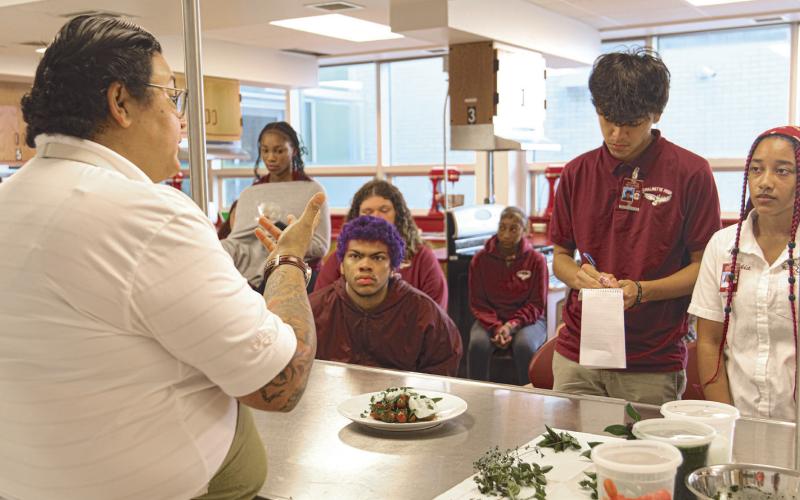 Chef Melissa Araujo demonstrates plating techniques, told stories of her cooking journey, and shared delicious bites to Chalmette High School students.