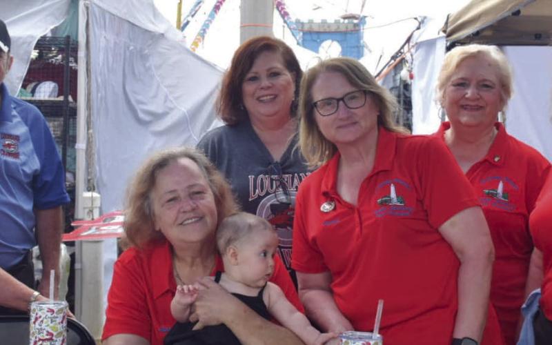 Volunteers helping to run the Louisiana Crawfish Festival pose for a photo.