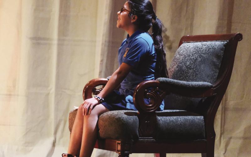 Alyssa Franatovich watches her play, performed by Prescription Joy, from the chair of honor on stage.