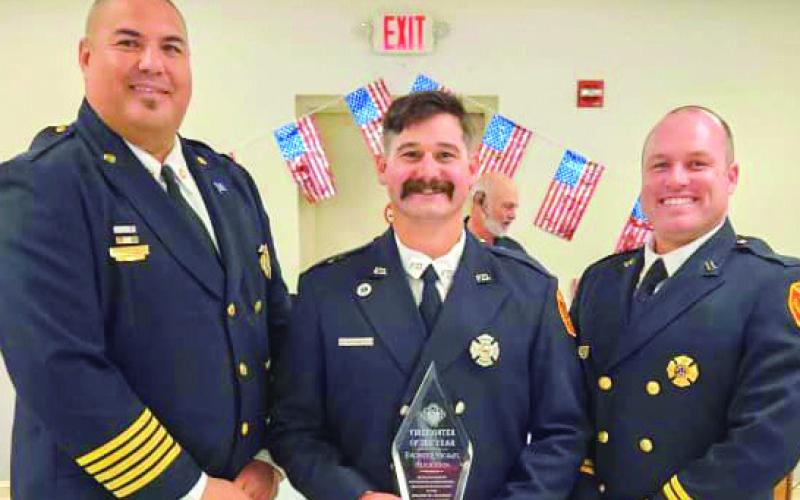 Pictured, from left: Fire Chief Earl Borden Jr., Michael Henderson and Captain Justin Sager.