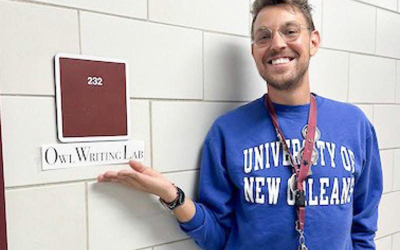 Justin Templet standing outside of Room 232, Chalmette High School's O.W.L. Writing Lab.