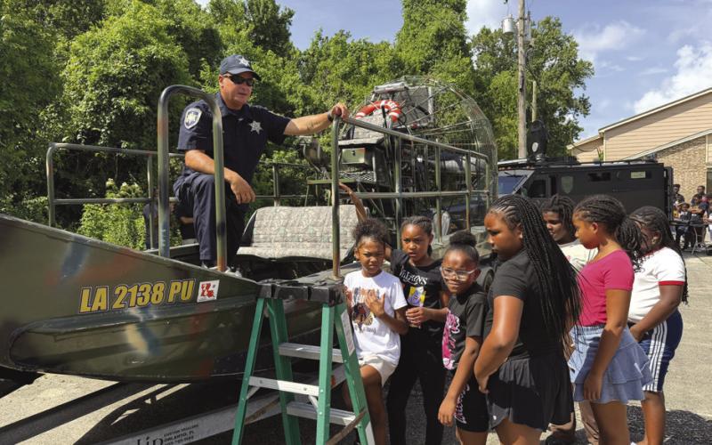 Sgt. Dusty Gould of SBSO's Marine Division showcases one of the division's airboats, giving campers a . rsthand look at the specialized equipment deputies use during search-and-rescue operations and other emergency responses.