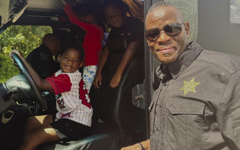 Campers explore the SBSO Special Operations Division SWAT truck with Lt. Donald Johnson Sr. of the Special Operations Division.