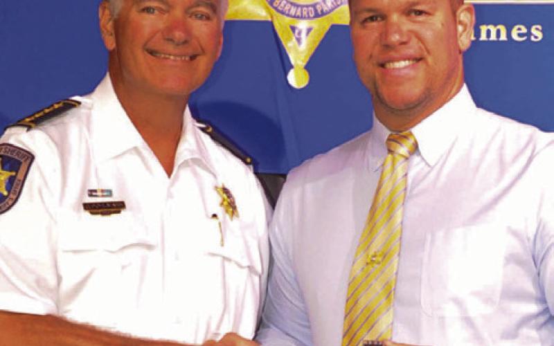 St. Bernard Sheriff James Pohlmann presented a Lifesaving Medal to Maj. Daniel Bostic, commander of the Special Investigations Division, right.