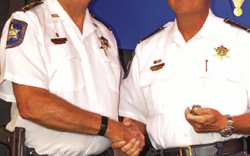 St. Bernard Sheriff James Pohlmann received a Lifesaving Medal from Chief Deputy Richard Baumy, left.