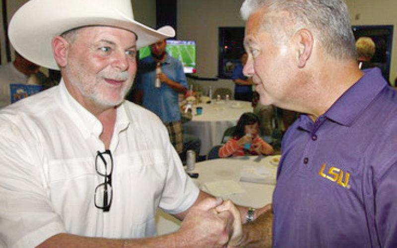 Two old friends... Jimmy Pohlmann has a congratulations hand shake with Louie Pomes.