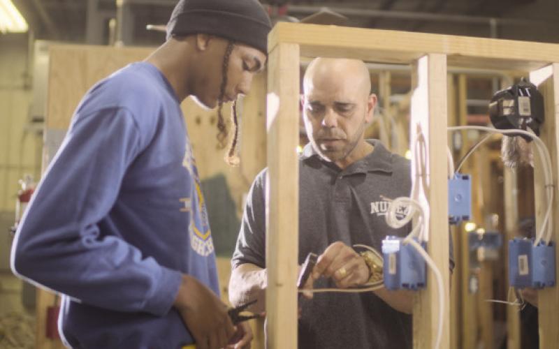 Nunez Community College Instructor, Steve Baiamonte, teaches a student in Electrical Construction, a program in which Nunez o ers three di erent certi. cates and degrees. Electrical, construction, and HVAC trainings will all be enhanced at Nunez with the $1 million Gable Grant award from the Lowe's Foundation.