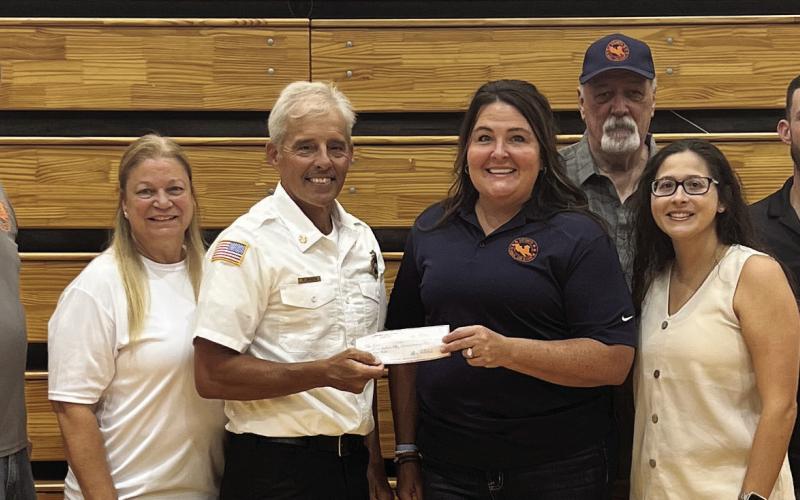 Pictured are the members of the St. Bernard Sports Hall of Fame Board of Directors — Melissa Barbay Gayé (President), Shane Quirk (Vice President), April Hagadone (Secretary), Kelli Plaiscia, Rene Hyer and Roy Cortes — and Firefighter Mike Dragon (third from the left)