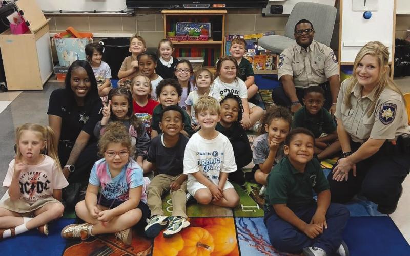 Dep. Paradise Donaldson, Dep. Guan Quinn and Dep. Victoria Corteaux, all of the Corrections Division, participated in Joseph Davies Elementary School's Literacy Week.