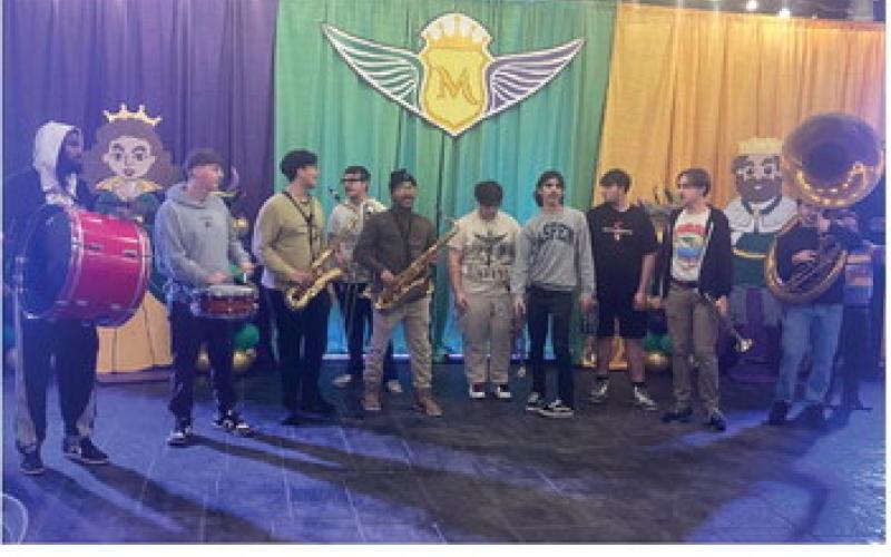 Members of the Chalmette High School Brass prepare to lead a second line procession after the royal court of the krewe had been selected.