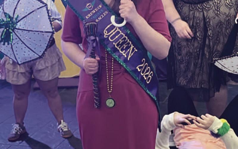 Krewe Queen Sarah Hendricks gets ready to second line after accepting her crown.