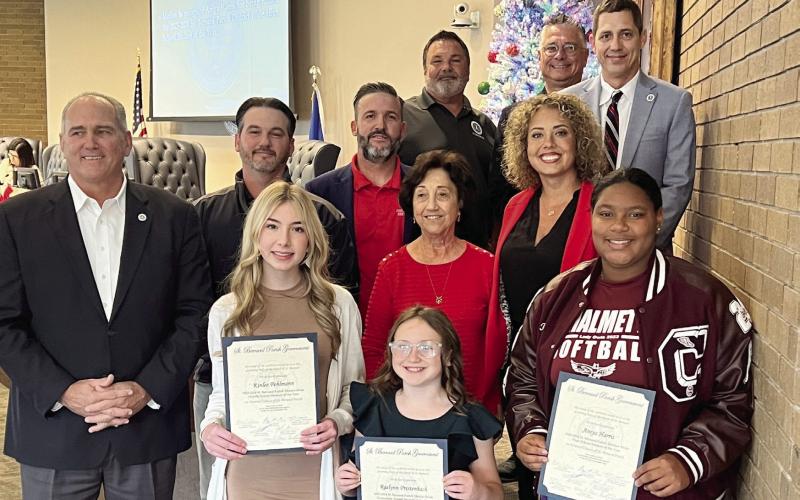 St. Bernard Parish Government Council Members and Parish President Guy McInnis stand alongside St. Bernard Parish's District-wide students of the year at the Dec.19 Council meeting. Raelynn Prestenbach, Kinlee Pohlmann, and Aniya Harris were the respective winners of the elementary, middle, and high school divisions.