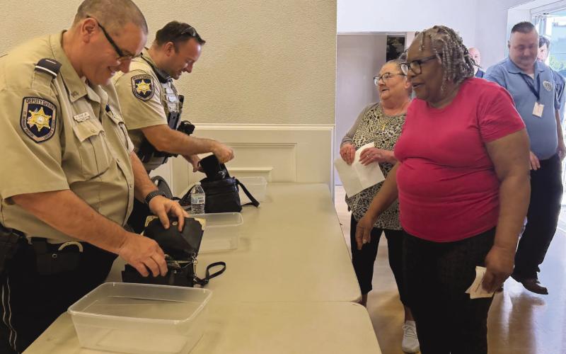 SBSO Lt. Keith Gioe Jr., left, and Dep. Anthony Toups III, right, checked bags of participants during a mock evacuation exercise conducted in preparation for the 2026 hurricane season.
