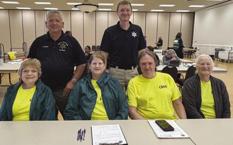 SBSO Lt. Eric Eilers, standing left, and Chaplain Dep. Aaron Johnson, standing right, with members of the Sheri 's O ce Community Emergency Response Team, or C.E.R.T. team. They