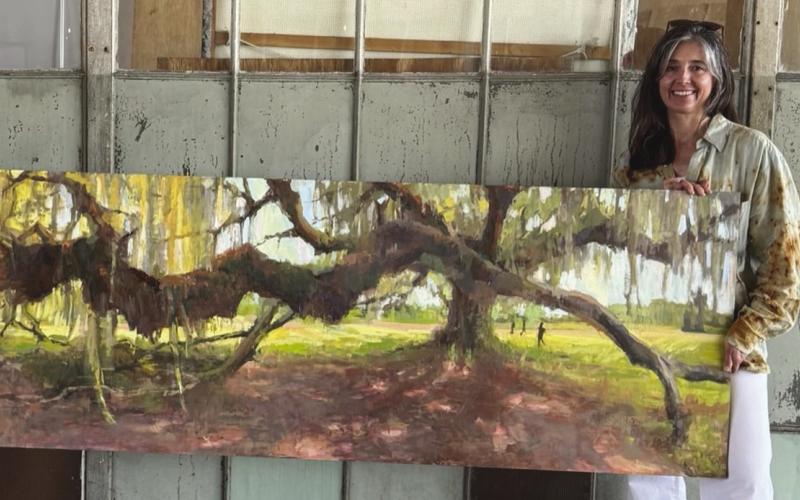 Sabrina Schmidt happily reunited with her painting, Dueling Oaks.