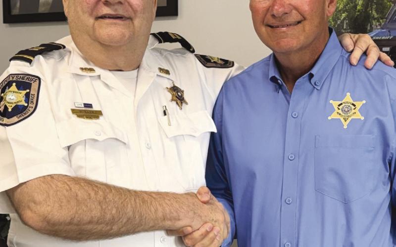 Sheri Jimmy Pohlmann congratulates Capt. Barr on his years of service.