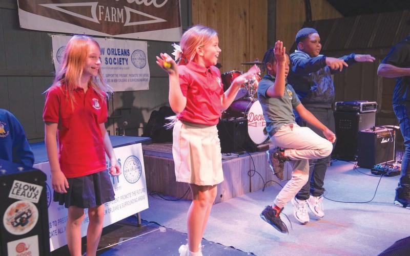 SBPPS 4th Grade Students left to right: Makayla Brown, Stella Harney, Maya Deselles, Chulo Walker, and A’soni Dobard dance on stage while Bruce “Sunpie” Barnes plays accordion at Blues in the Schools on Docville Farm.