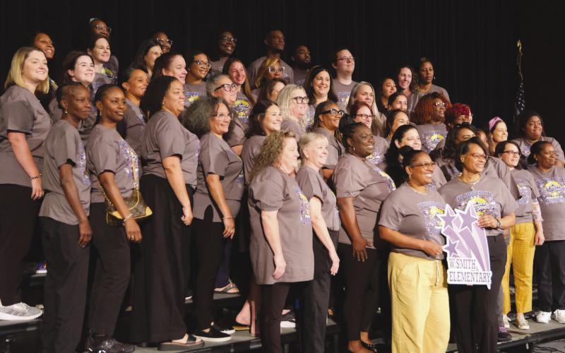 The sta of W. Smith, Jr. Elementary smiles for a sta photo.