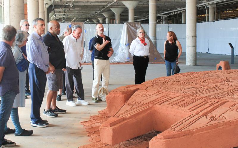 Executive Director of Prospect New Orleans, Nick Stillman, discusses one of the Prospect.6. artwork on display at the Ford Motor Plant in Arabi.