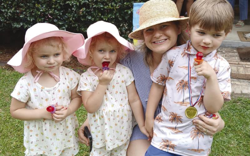 The Madary great grandchildren a set of twin girls, Mama, and the young man of the family, all dressed for a Easter family day in the country.