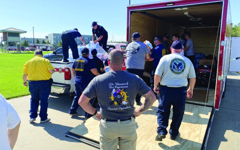 Members of the St. Bernard Fire Department prepare to leave for Florida.