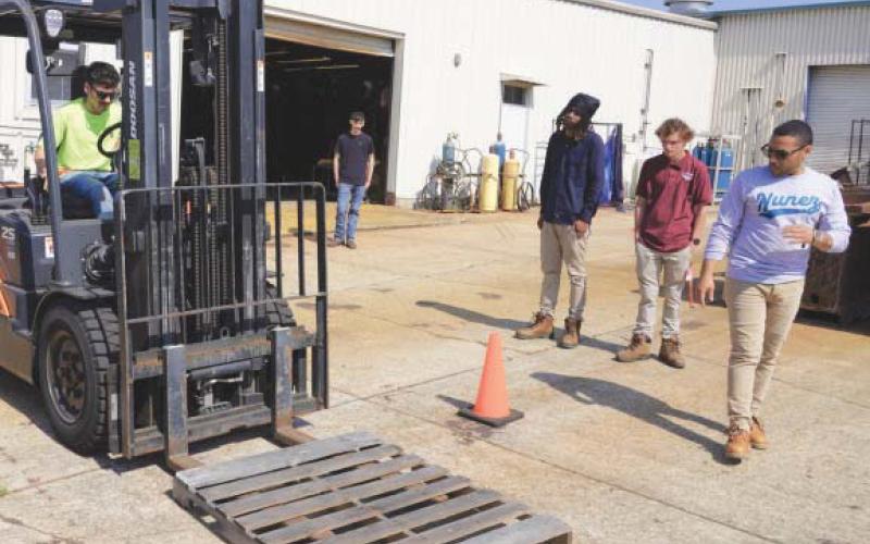 Nunez Instructor Jesús Melendez leads a forklift certi. cation class on the Nunez campus. Forklift is one of 8 equipment certi. cations and . ve workplace certi. cations available through Nunez's six-week Heavy Equipment program.