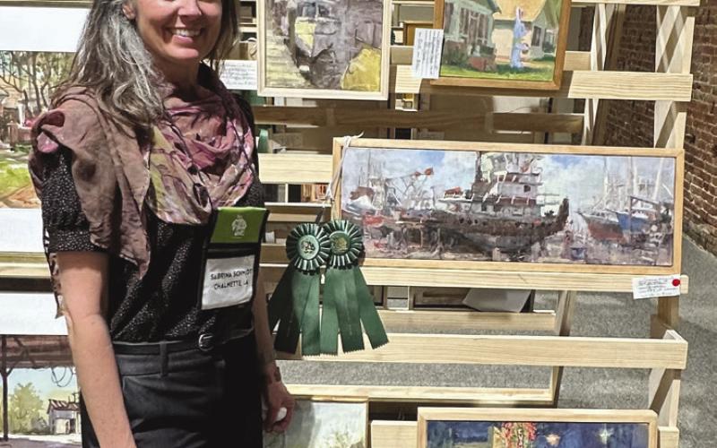 Sabrina Schmidt with her award of best in show and artist choice in the Teche Plein Air contest in New Iberia.
