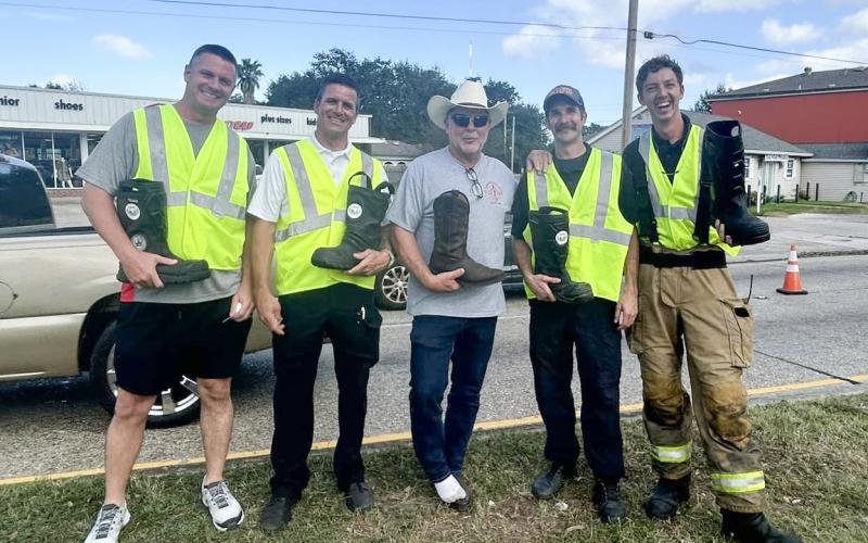 Parish president Pomes and firefighters help collect donations for the League of Angels.