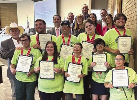 Exceptional Athletes: Parish President Louis Pomes and council members pose for photo with members of the Exceptional Athletes of St. Bernard.