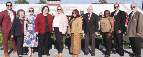 Left to Right Principal Will Schneider, Assistant Principal Cookie Mundt, School Board President Katherine Lemoine, Superintendent Doris Voitier, School Board Members Carly Creason, Rosiland White, Principal Wayne Warner, School Board Members Keisa Rodney, Sean Warner, Henry Rodriguez III.