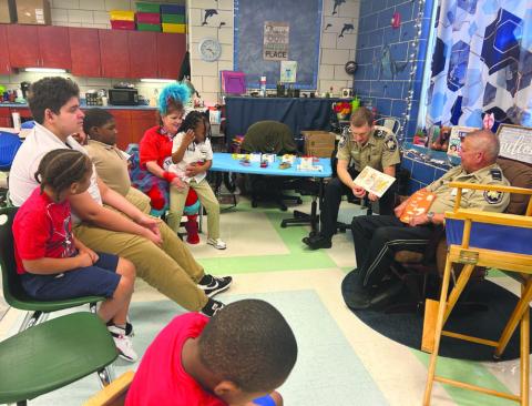 Lt. Eric Eilers of SBSO’s Community Relations Division, right, and Chaplain Dep.Aaron Johnson spent time with Arabi Elementary students during the school’s Literacy Week festivities.