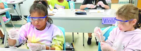 The STEAM Department at Nunez Community College will o er more than 10 multi-day camps for young students this summer. Pictured, students conduct an experiment in a past Astro Camp at Nunez.