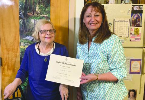 Francois deLery Chapter, Daughters of the American Revolution, past Regent Gayle Buckley (R) recently presented former Chaplain Christine Morrison (L) with a certificate and pin for Excellence in Community Service. Christine hosts poetry writing sessions at her assisted living facility and does online work with the Franciscans. Christine is a former resident of Chalmette.