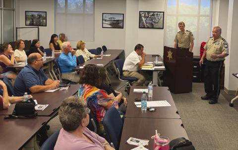 Lt. Eric Eilers, right, and Chaplain Dep. Aaron Johnson provided attendees with practical safety tips and strategies to reduce their risk of becoming a victim during the St. Bernard Sheri 's O ce "Refuse To Be A Victim” class.