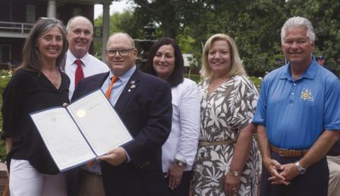 Sabrina Schmidt receives a State Legislature Proclamation from Louisiana Representative Mike Bayham during St. Bernard Day at the Capitol. Sharing the moment was Sabrina Schmidt, Judge William McGoey, Rep. Mike Bayham, Assessor Jay Lynn Turner, Judge Kim Jones, and Sheri James Pohlmann.