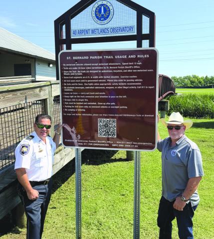 Col. Chad Clark, commander of the SBSO Criminal Investigations Bureau, left, and Parish President Louis Pomes stand beside a new trail safety sign installed through a partnership between SBSO and SBPG to enhance safety along the parish’s bikeway and trail system. The initiative also includes the installation of more than a dozen surveillance cameras along the trails.