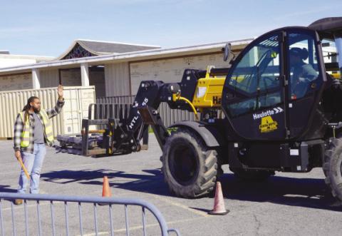 Heavy Equipment students practice operating and directing a telescoping forklift on the Nunez campus.