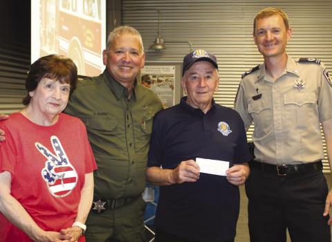 Lt. Eric Eilers, second from left, and Chaplain Aaron Johnson, far right, accept a $100 donation for the Junior Deputy Academy from Hilton Preau, president of the Vietnam Veterans of America, St. Bernard Chapter 550, and Patricia Preau. Junior Deputy Academy is an annual summer program for children ages 10 to 12 designed to foster community pride and teach youngsters about law enforcement.