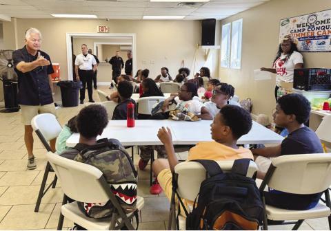 Sheri Pohlmann talks with campers during Christian Fellowship Church’s Camp Conquer Summer Camp Law Enforcement Day. The Sheri