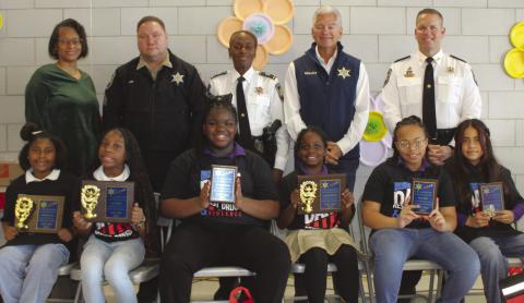 W. Smith Jr. Elementary School fifth graders who were named SBSO D.A.R.E. program essay contest winners are, first row, from left: Anaya Williams, first place; Kyrie Major, first place; Breanna Dixon, second place; Ja'harii Cosse, first place; Kylie Sider, second place; and Angela Ticas Turcios, second place. With the winners are, second row, from left, are: W. Smith Elementary School Principal Cassandra Reddick, Sgt. Brandon Lewis, Capt. Lisa Jackson, Sheri James Pohlmann and Col. Daniel Bostic.