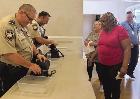 SBSO Lt. Keith Gioe Jr., left, and Dep. Anthony Toups III, right, checked bags of participants during a mock evacuation exercise conducted in preparation for the 2026 hurricane season.