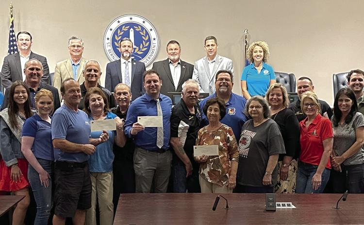 St. Bernard Parish Council and Parish President Guy McInnis accept check donations from the Knights of Columbus's Archbishop Rummel Council #5747.