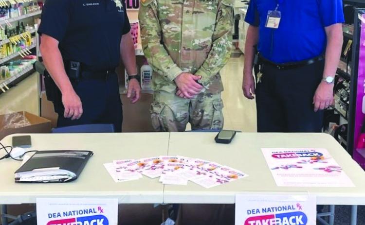 From left: Special Investigations Division Narcotics Agent Lt. Cli ord "Chip" Englande, Sgt. Barry Sevin with the National Guard Counter Drug Program, and Walgreens Manager Kevin Krul.
